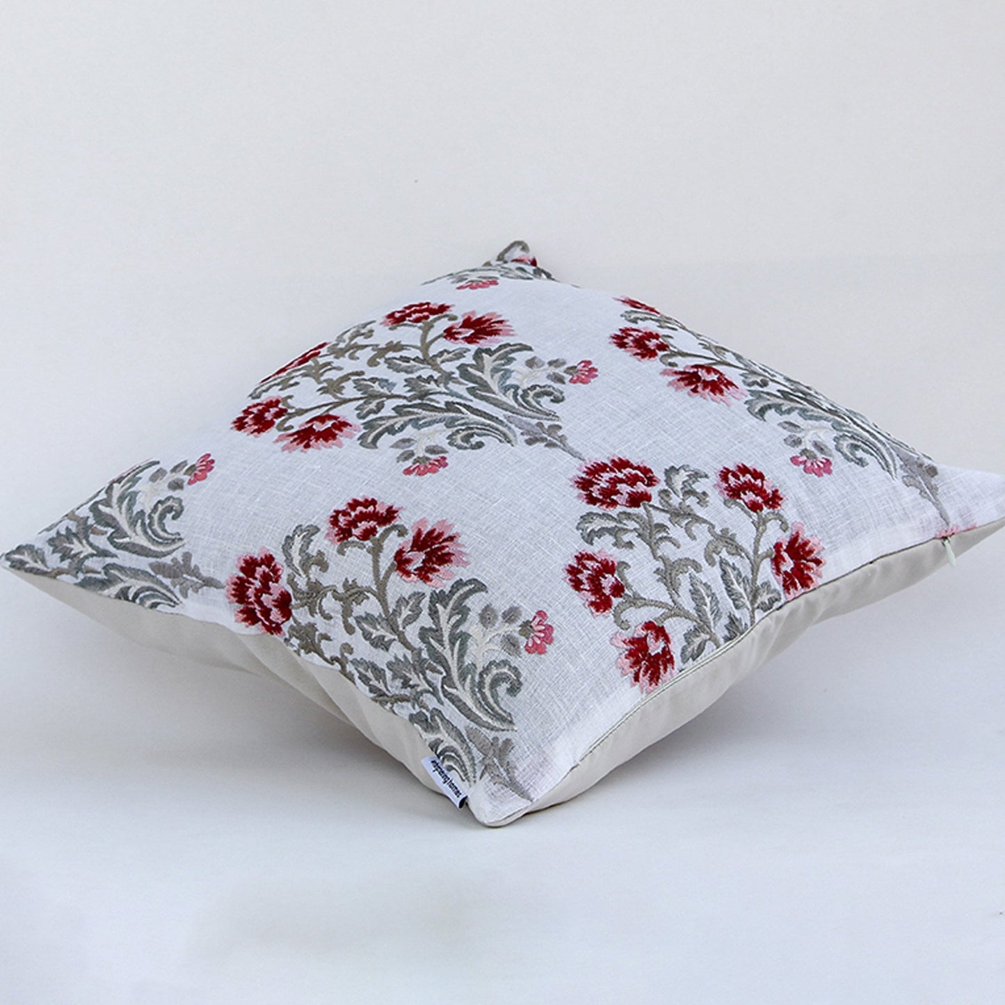 Floral embroidered cotton cushion shown on a clean white background showcasing intricate red and grey stitched motifs ideal for elegant home decor accents.