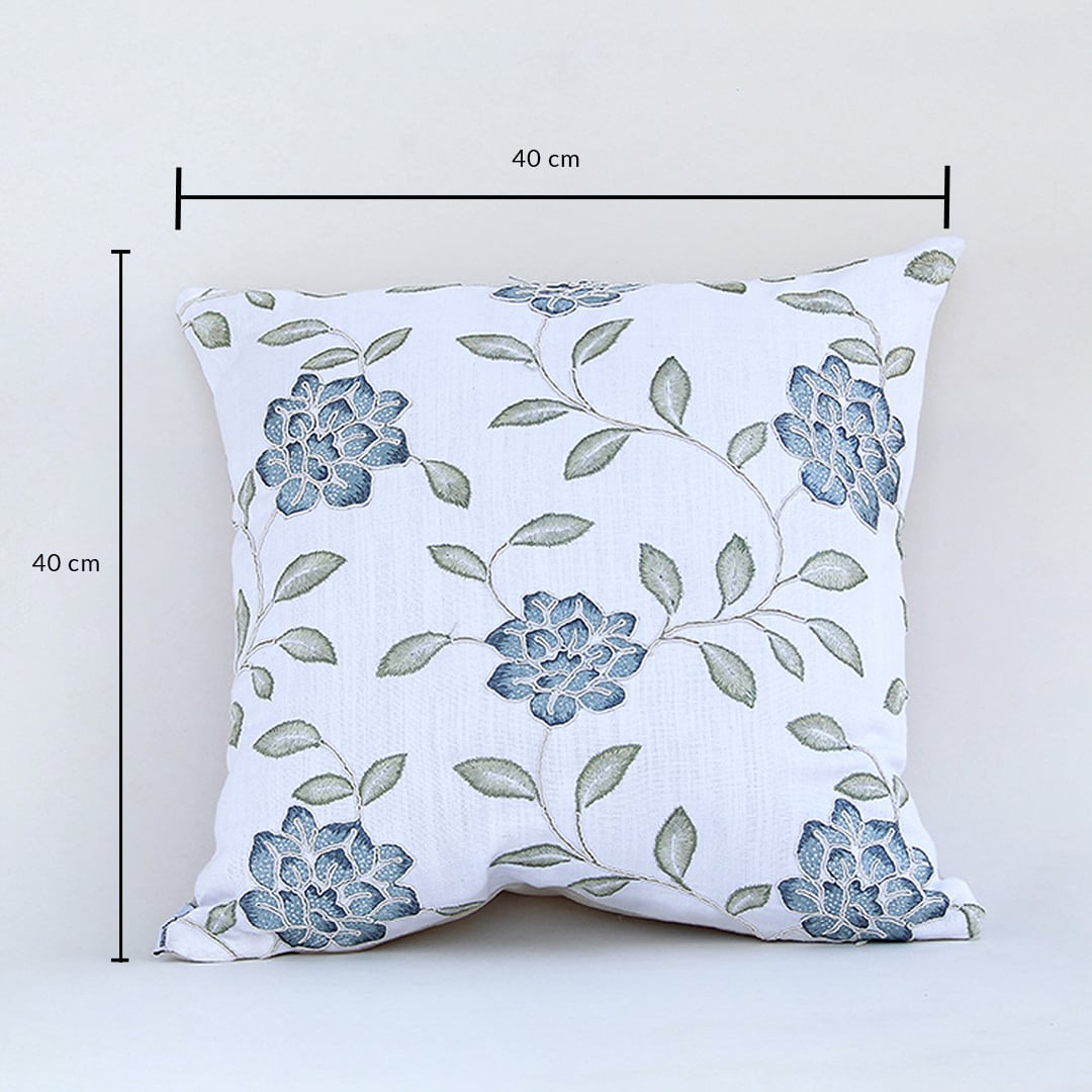 Cotton cushion with blue floral embroidered design measured at 40 cm by 40 cm displayed on a white background showing its square decorative shape.