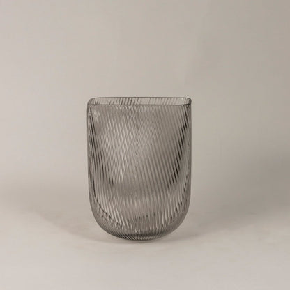 Smoky gray ribbed glass vase with a modern curved design displayed on a plain white background.