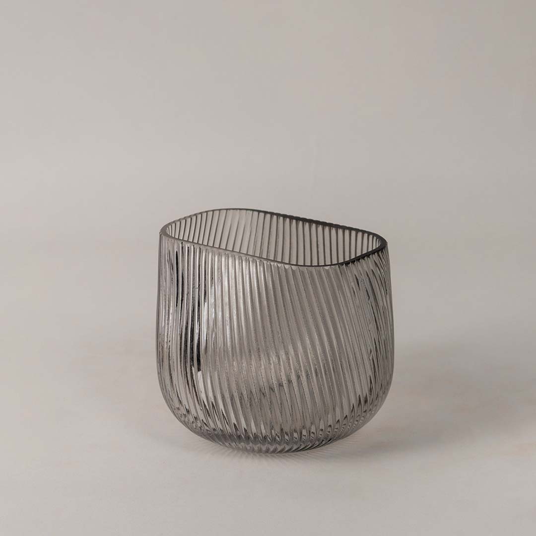 Side view of ribbed smoky gray glass vase highlighting its elegant curved design and fine textured surface.