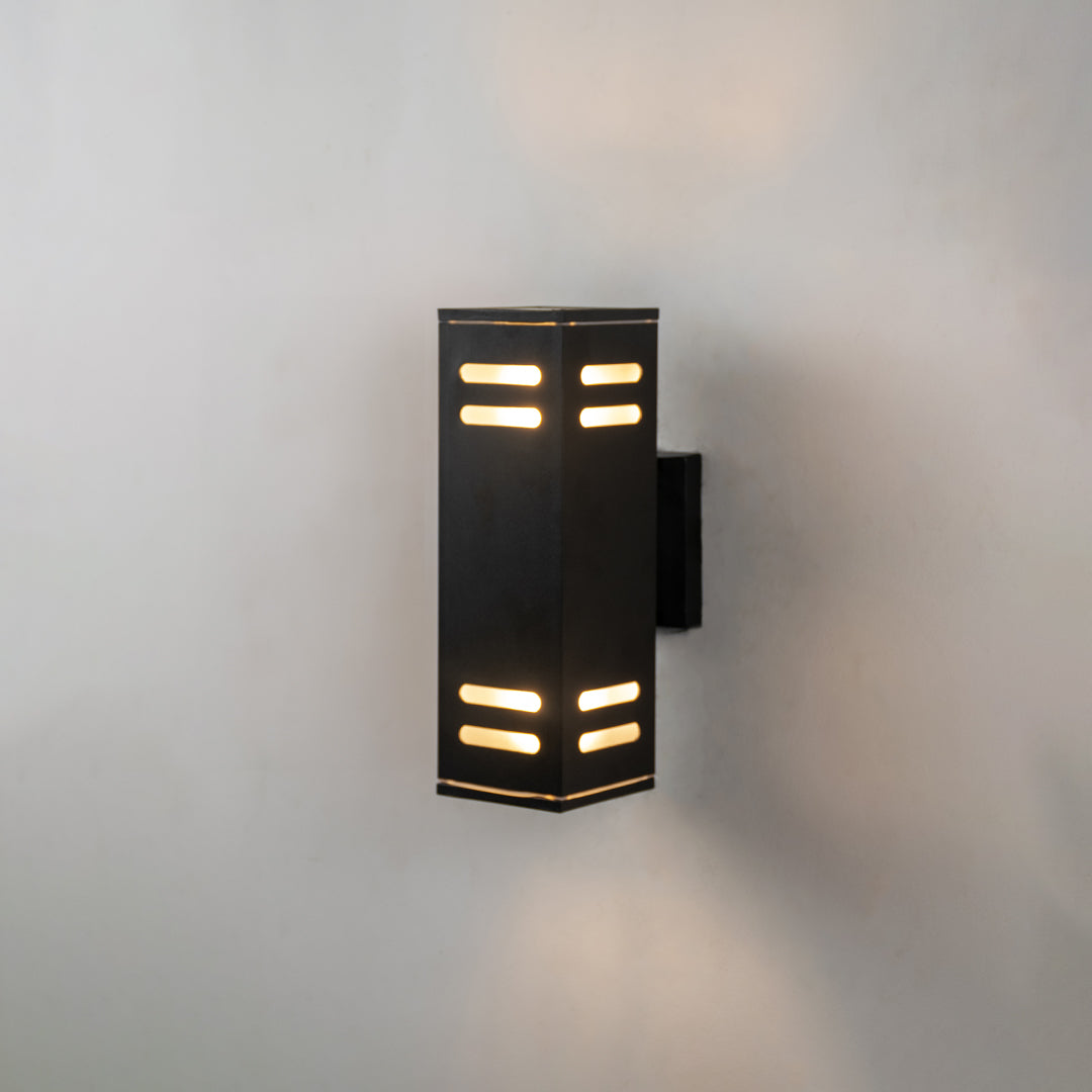 Black metal outdoor wall light with geometric beam lighting for modern patio and entryway wall decor.