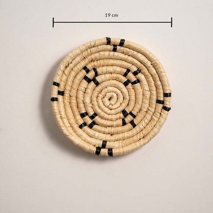 Small round woven wall basket measuring 19 cm in diameter featuring natural beige coils and black accents displayed on a white background.