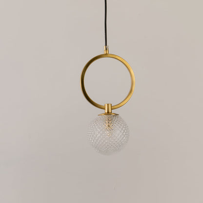 Gold ring pendant light on a white background with the light off highlighting its sculptural modern form and glass detailing.