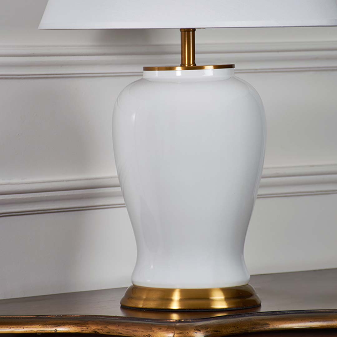 Glossy white ceramic table lamp base with gold metal accent designed for sophisticated bedside and living room decor.