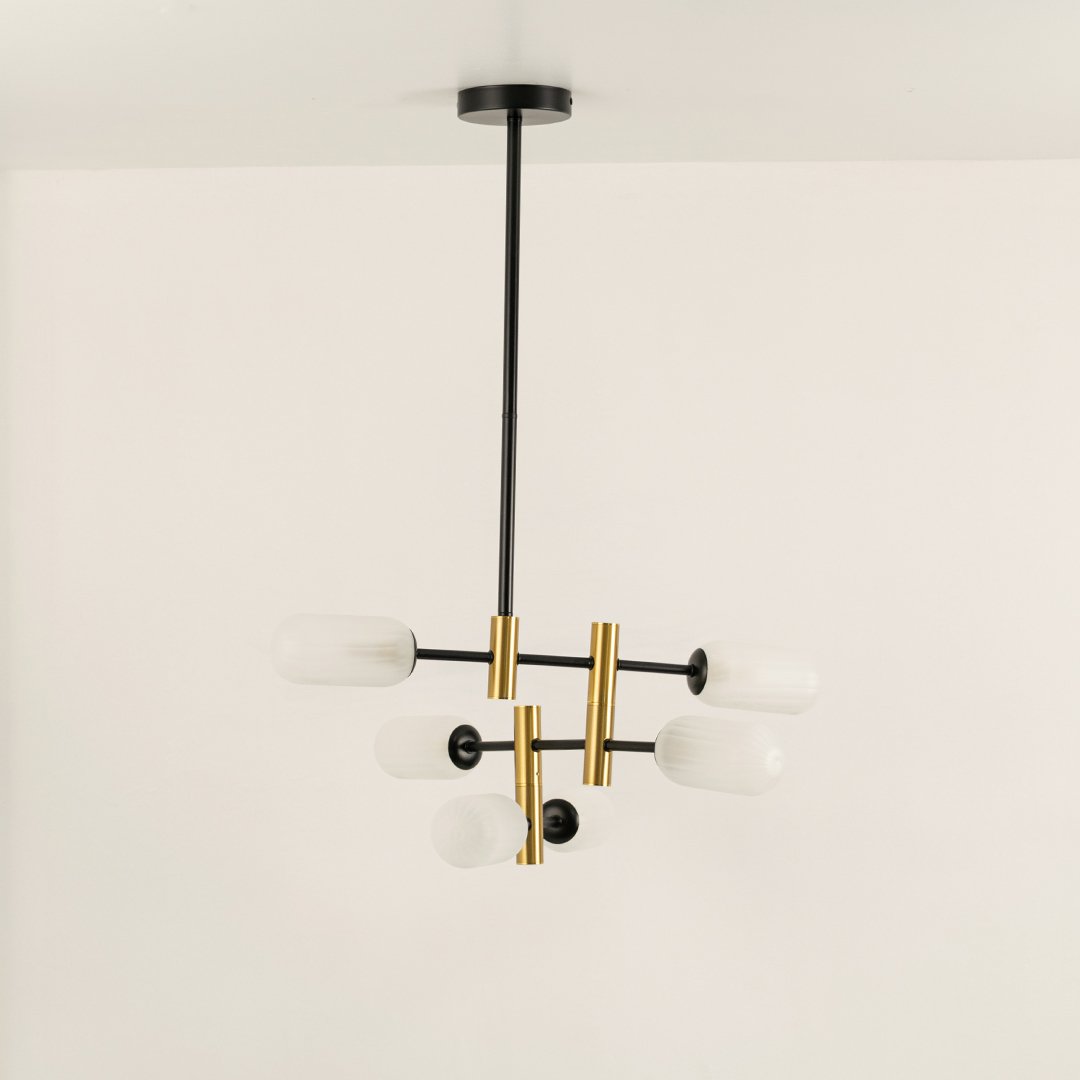 Gold and black metal chandelier with frosted glass tube shades designed for stylish modern ceiling lighting indoors.