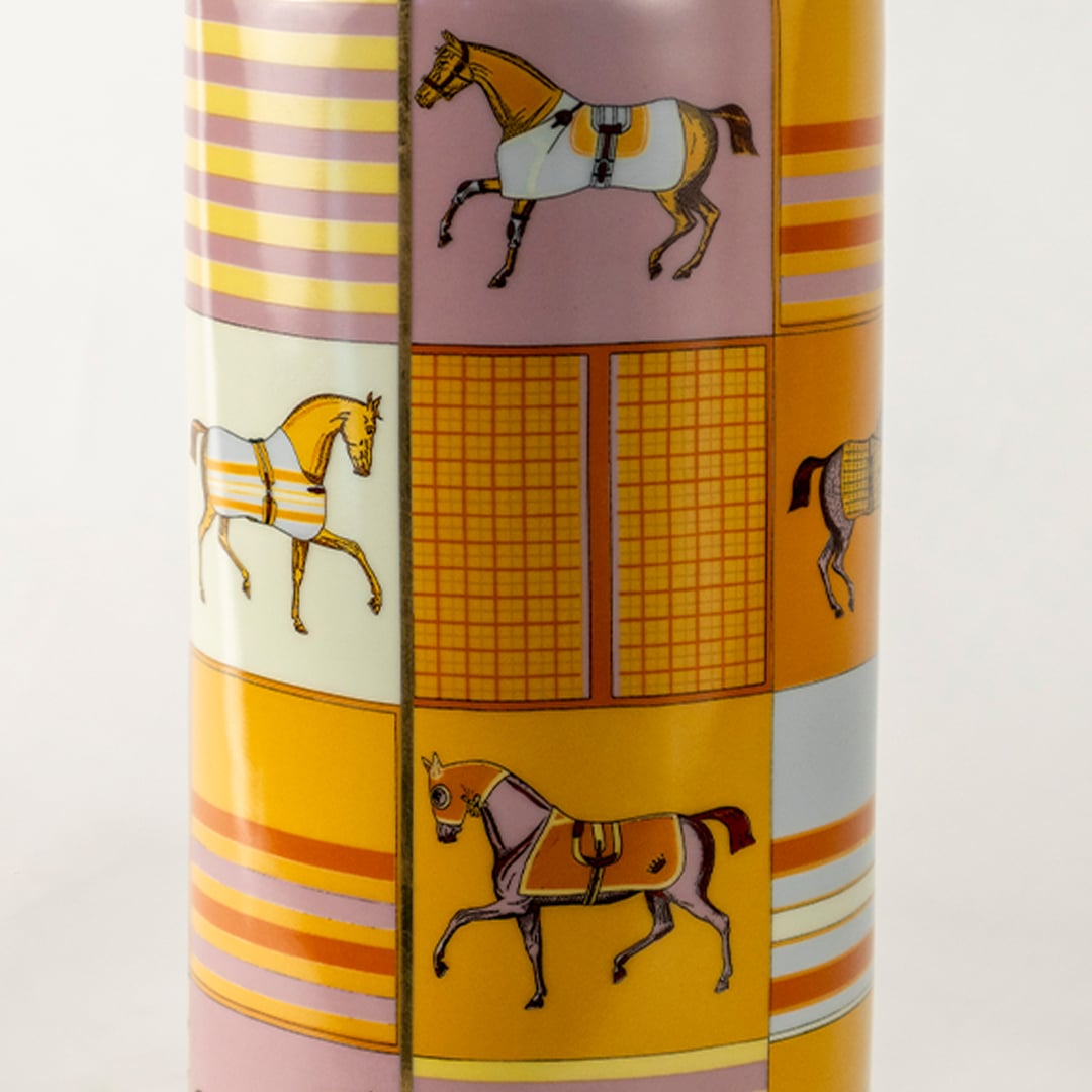 Tall gold ceramic jar with horse artwork and geometric patterns shown in a closeup view displaying vivid detailing artistic elegance and premium décor appeal for luxury interior styling.