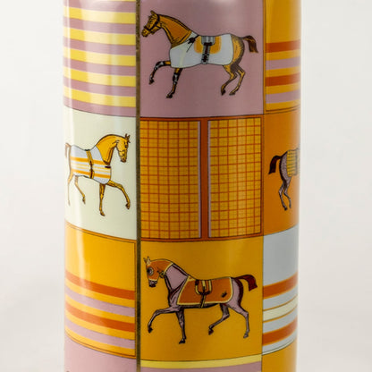 Tall gold ceramic jar with horse artwork and geometric patterns shown in a closeup view displaying vivid detailing artistic elegance and premium décor appeal for luxury interior styling.