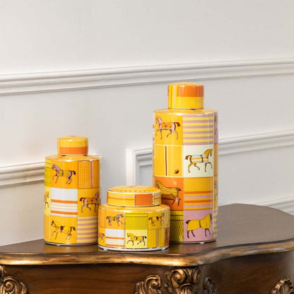 Yellow ceramic jars with floral designs placed on a wooden console table creating a lively decorative accent that brightens and enhances interior décor spaces.