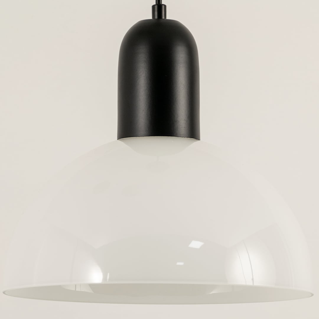Black and white metal pendant light illuminated to display contemporary ceiling lighting with minimalist modern styling.