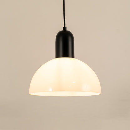 Modern black and white pendant light hanging in stylish dining room and contemporary kitchen decor styling.