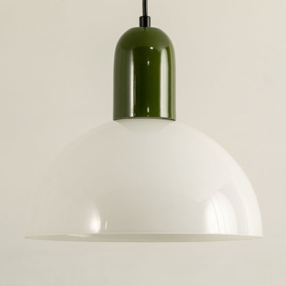 Closeup of pendant light with green metal top and white dome shade highlighting smooth finish for modern kitchen or dining decor.