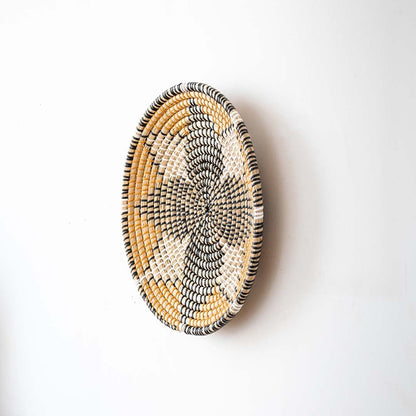 Side view of handwoven wall basket decor made of rustic natural fiber with boho style for wall decoration.