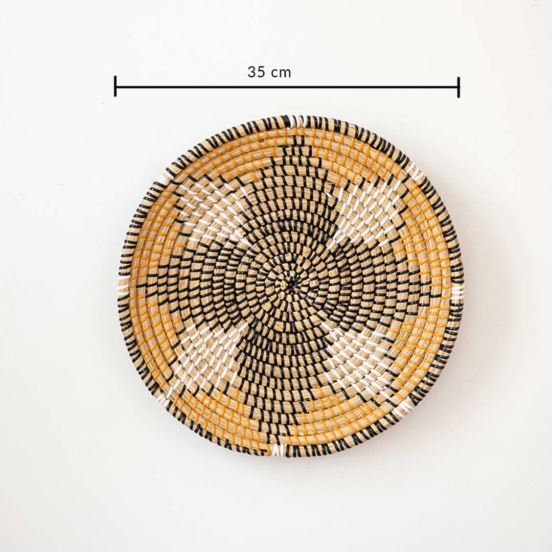 Handwoven wall basket decor in natural and black fiber shown with 35cm diameter for decorative wall use.