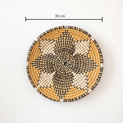 Handwoven wall basket decor in natural and black fiber shown with 35cm diameter for decorative wall use.