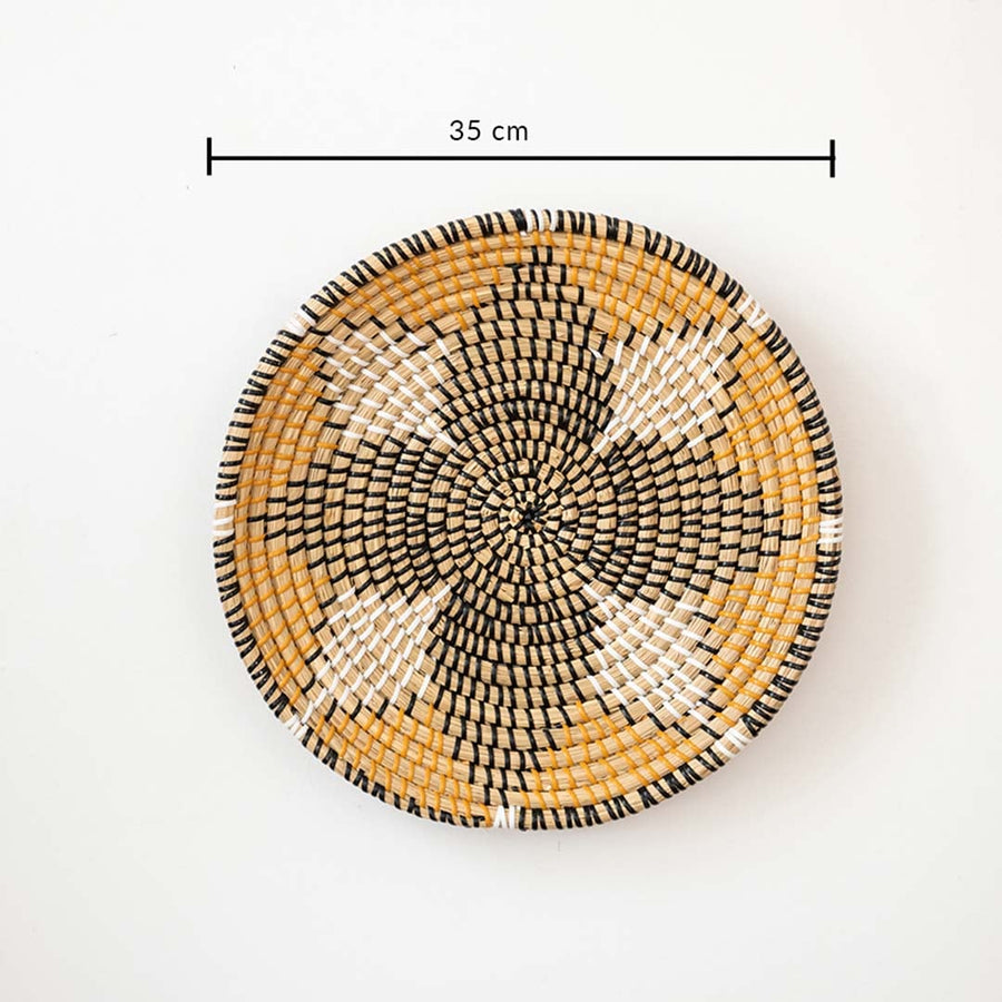 Handwoven wall basket decor in natural and black fiber shown with 35cm diameter for decorative wall use.