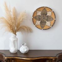 Handwoven wall basket used as boho wall decor in living room with rustic natural style and modern vase