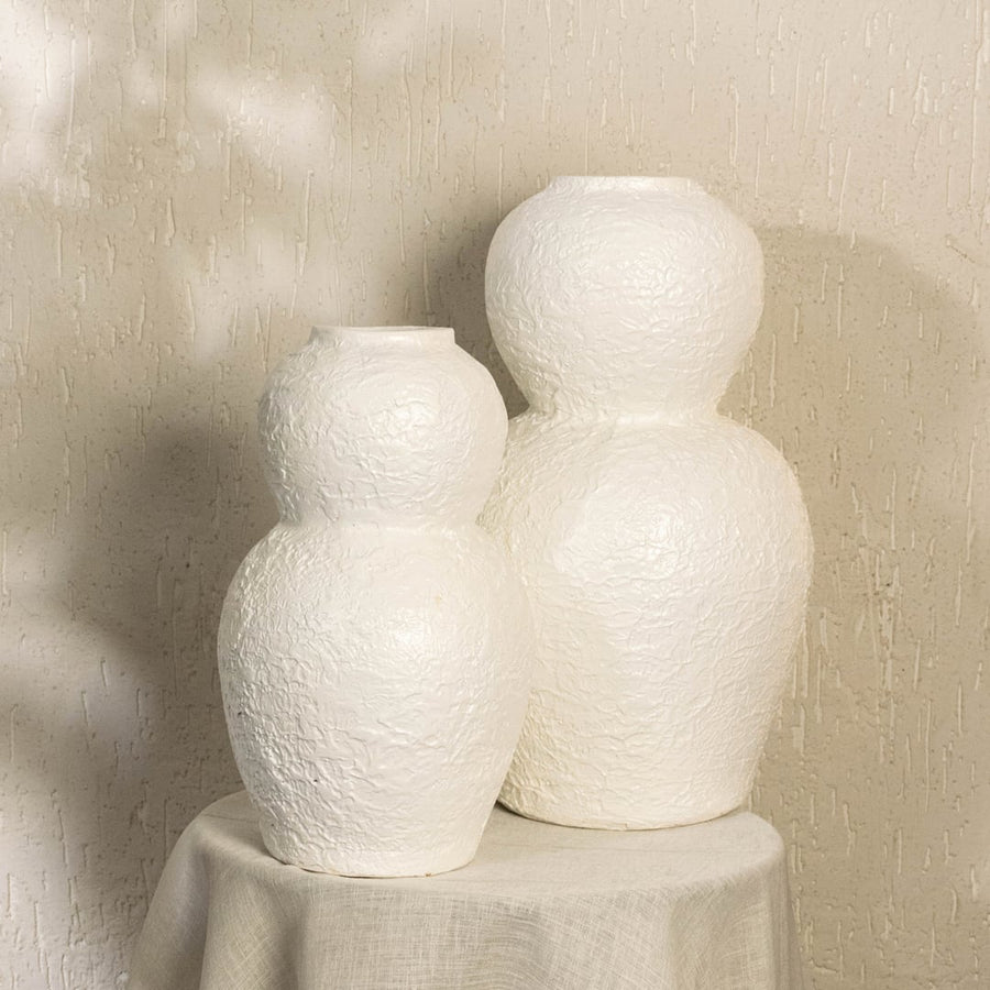 White textured decorative vase arranged with other decor pieces in a styled room creating a modern coordinated display for home interiors.