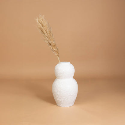White textured decorative vase placed in a curated interior setting enhancing shelves consoles and living spaces with natural artistic decor.