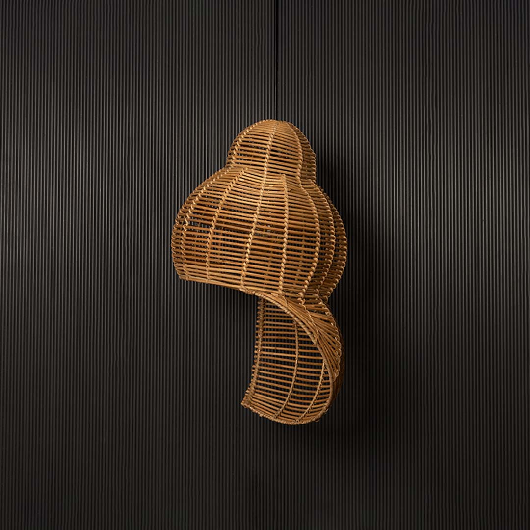 Double gourd rattan pendant light with bamboo frame in natural finish turned off against black background.