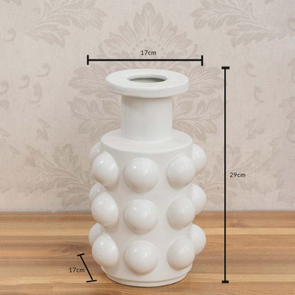 White ceramic vase measuring 29 cm in height and 17 cm in diameter with a glossy spherical textured surface.