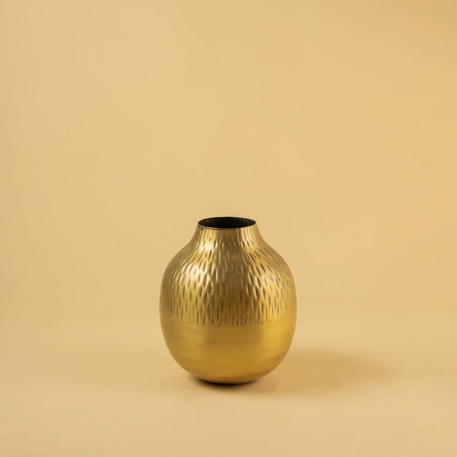 Gold hammered metal vase decor on clean white background perfect for modern shelves console tables and elegant home styling.