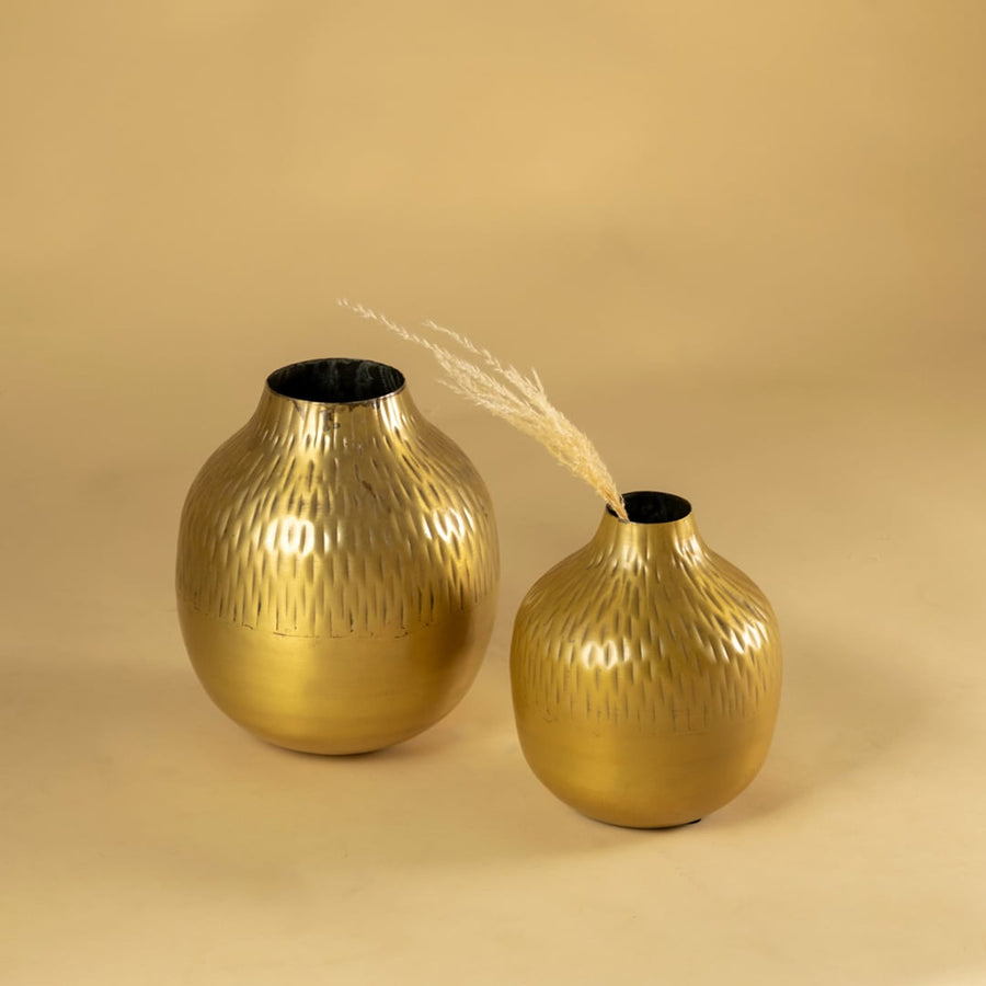 Gold hammered metal vase decor shown with matching pieces for a warm modern display on shelves console tables and styling areas.