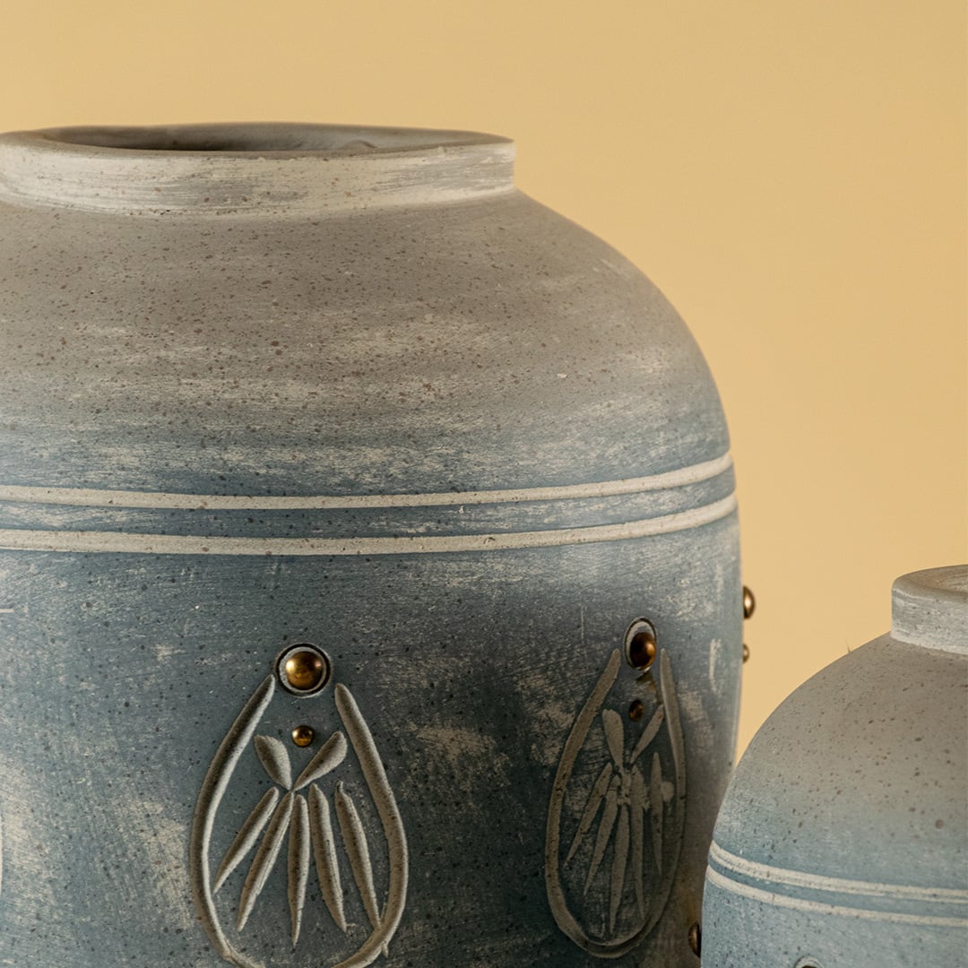 Detailed closeup of blue terracotta vase showing carved motif detailing and refined handmade texture ideal for decorative interior accents.