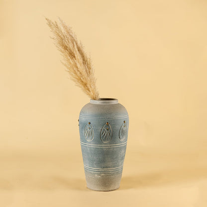 Blue carved terracotta vase styled in a warm room adding soft handcrafted charm and decorative detailing to modern natural home decor styling.