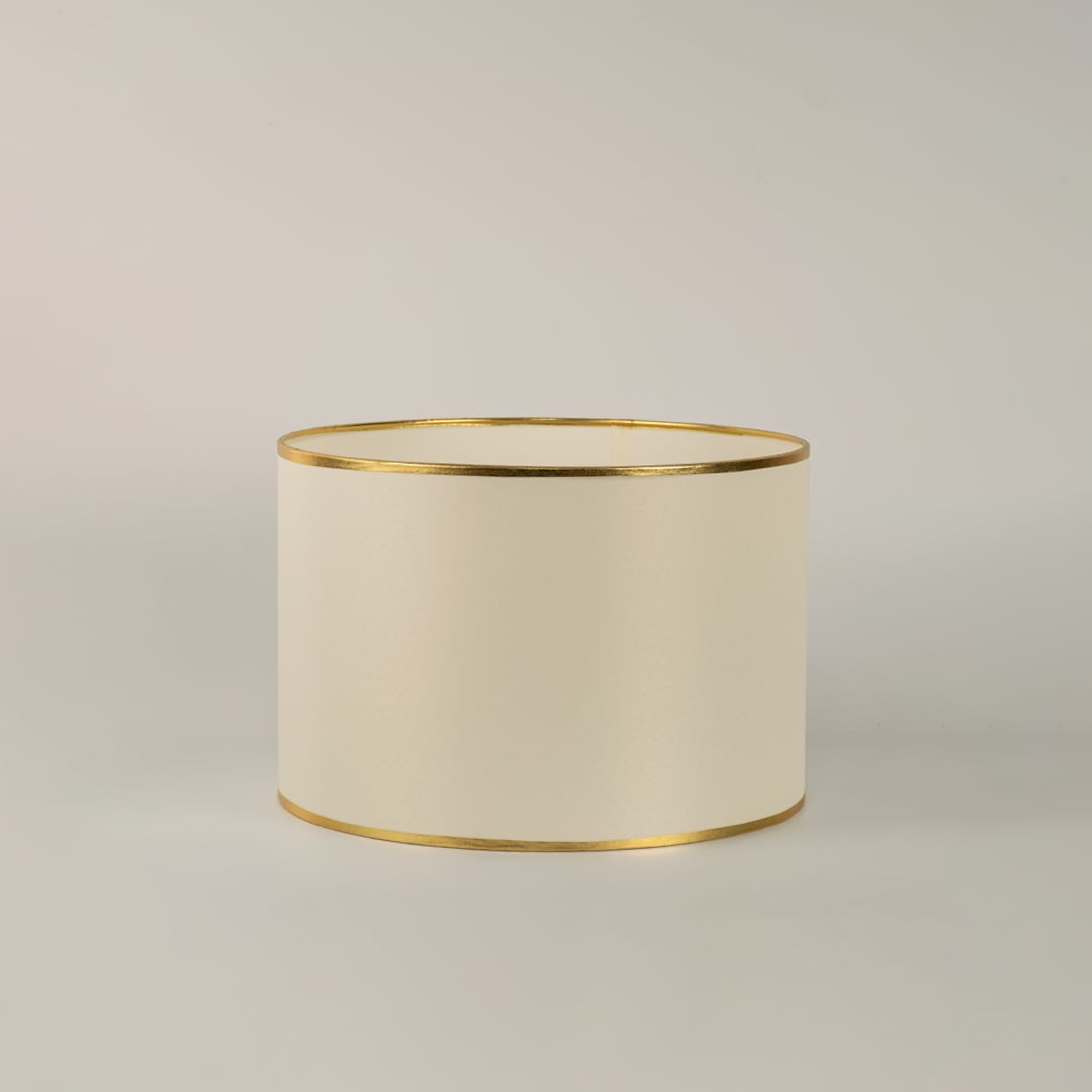 Lucent table lamp with white shade and gold crystal base displayed on white background with light turned on for interiors.