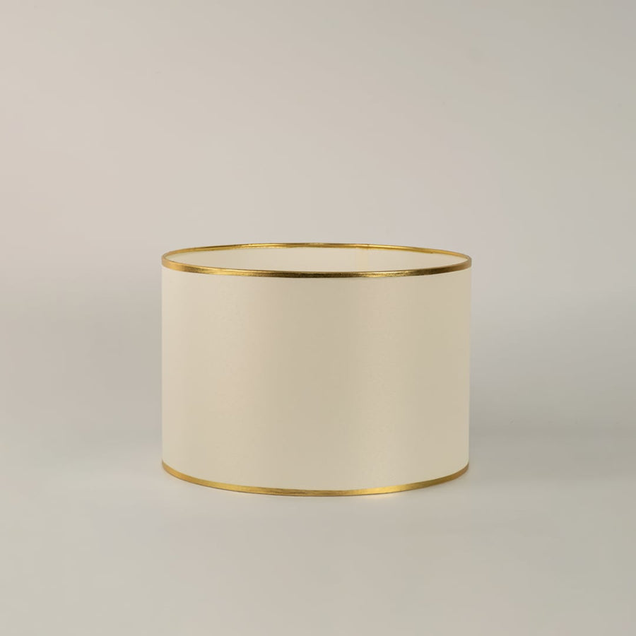 Lucent table lamp with white shade and gold crystal base displayed on white background with light turned on for interiors.