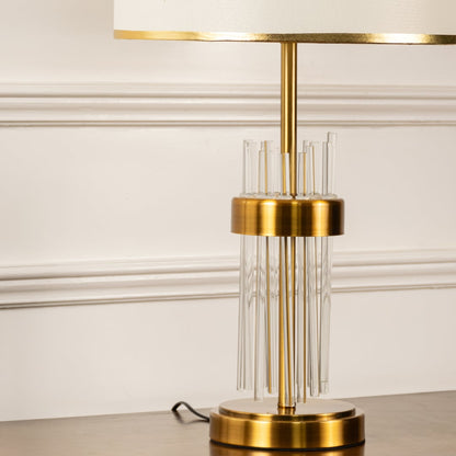 Lucent closeup showing gold base with vertical crystal rods and elegant white shade designed for modern luxury interiors.