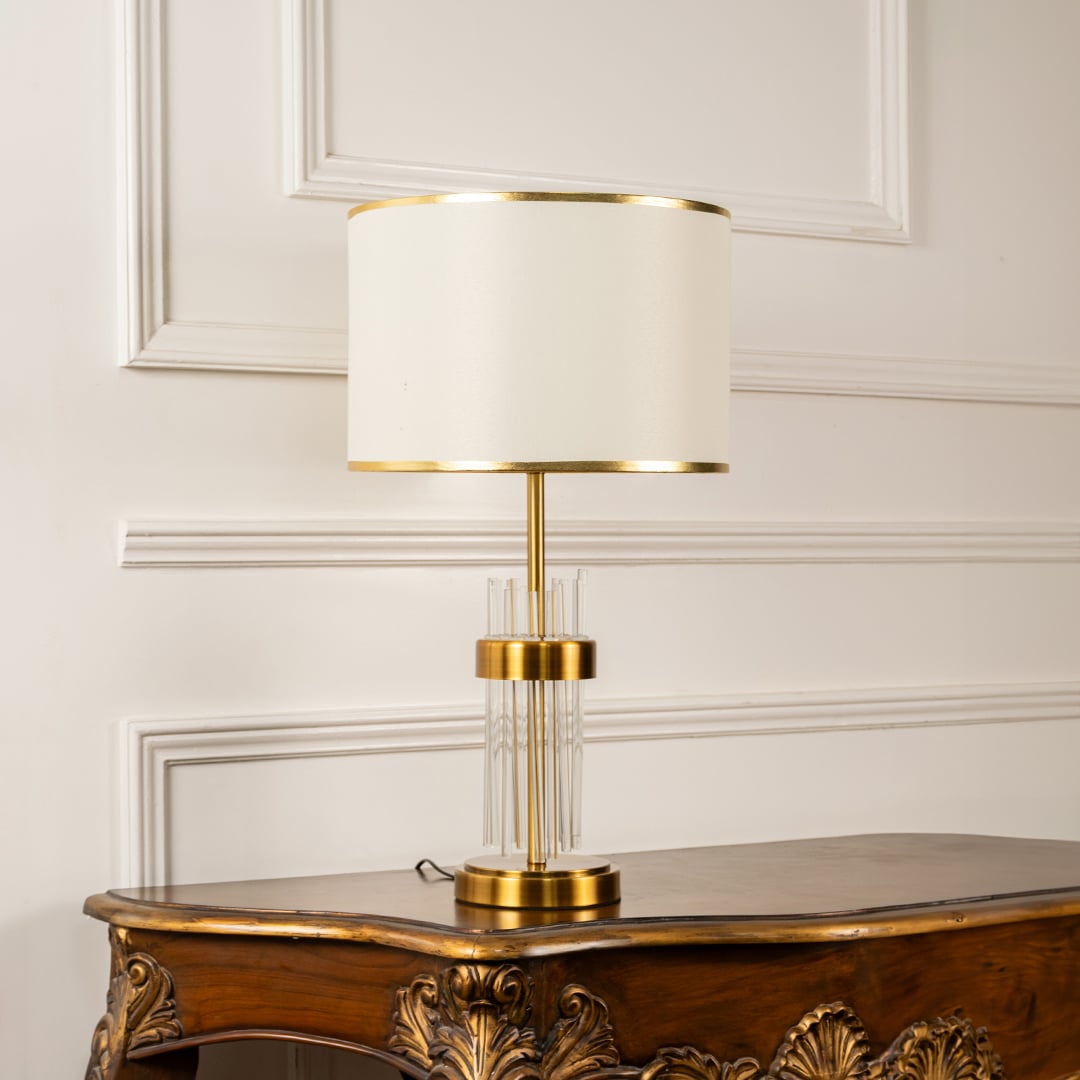 Lucent modern table lamp with gold and crystal base styled on wooden console for elegant living room lighting ambience.