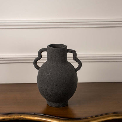 Side angle view of black ceramic vase with unique dual handles and matte finish ideal for living room or hallway decor.