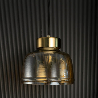 Smoked glass pendant light with gold metal top shown unlit on black background highlighting elegant form and luxury decor appeal.