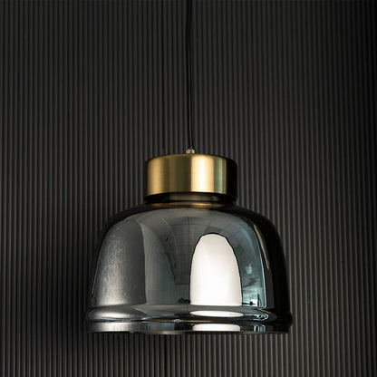 Smoked glass pendant lamp turned off with elegant gold top and semi-transparent glass body displayed against a black background.