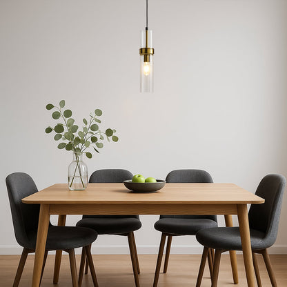 Elegant glass pendant light with warm glow hanging above a modern wooden dining table in a minimal room creating a calm and inviting ambience.