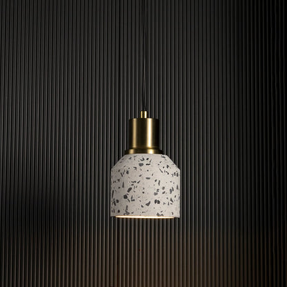 Terrazzo pendant light with warm glow highlighting brass and terrazzo texture for contemporary ceiling lighting.