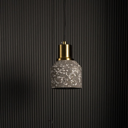 Pendant light with textured glass shade and gold metal holder displayed against dark background for dramatic decor lighting.