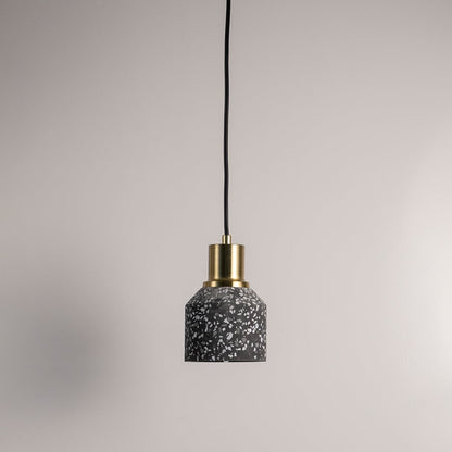 Black terrazzo pendant lamp with golden accent  turned off against a white background for a sophisticated industrial look.