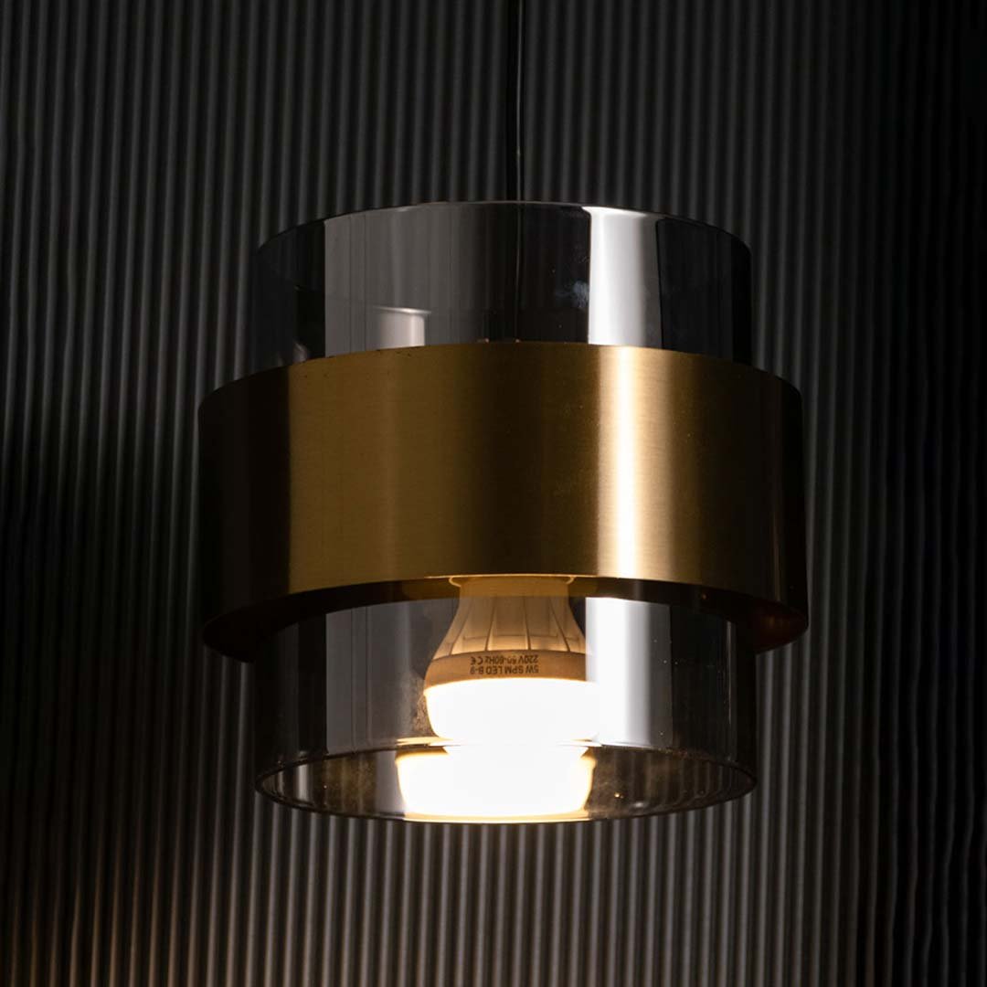 Light on white background image of black and gold glass pendant light for luxurious modern ceiling decor.