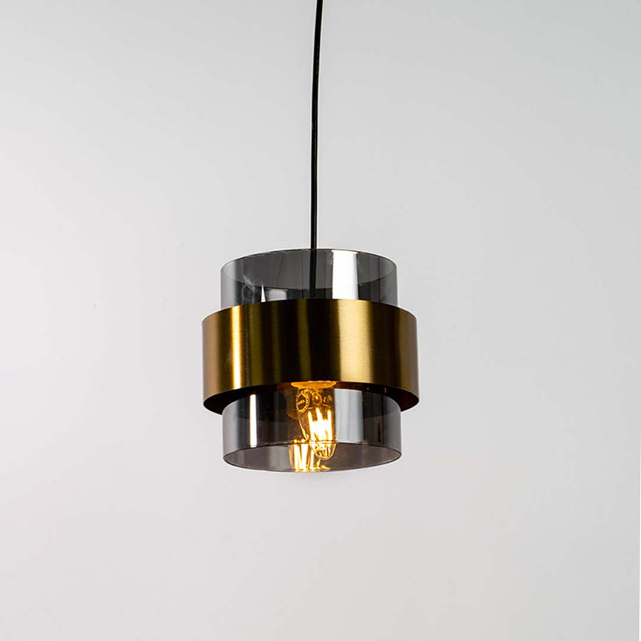 Black and brass metal pendant light with layered cylindrical design for contemporary home decor.