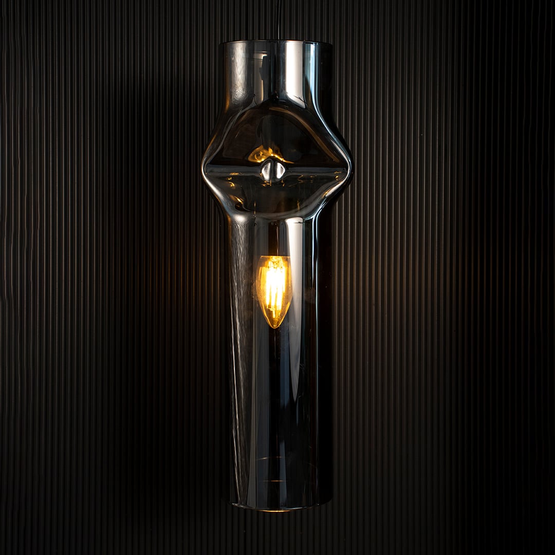 Chrome pendant light reflecting soft highlights against dark backdrop highlighting its elegant industrial design.