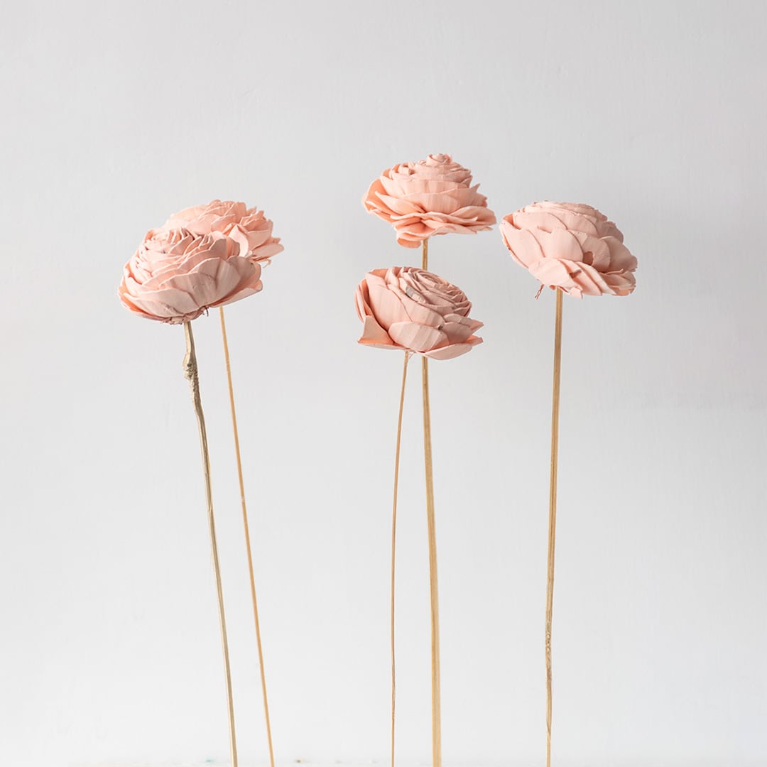 Set of peach sola flowers with natural wooden stems grouped together ideal for DIY vase arrangements and wedding decor.