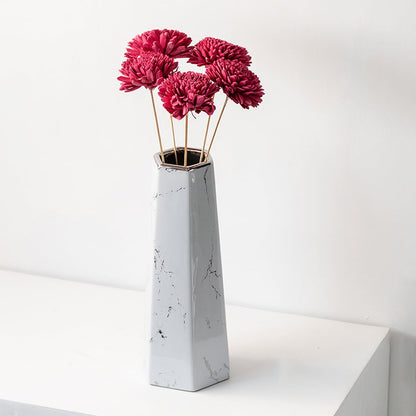 Pink sola flower sticks in a tall marble effect vase with artificial decorative flowers for home office and event decor.