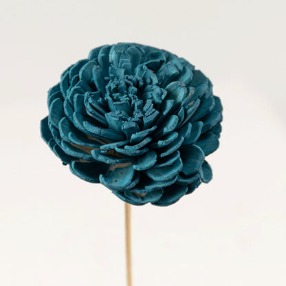 Closeup view of blue artificial flowers in glass vase showing petal texture and vibrant color for interior decoration.
