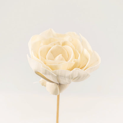 Detailed closeup of a white flower stick showing intricate petal layers and natural finish.