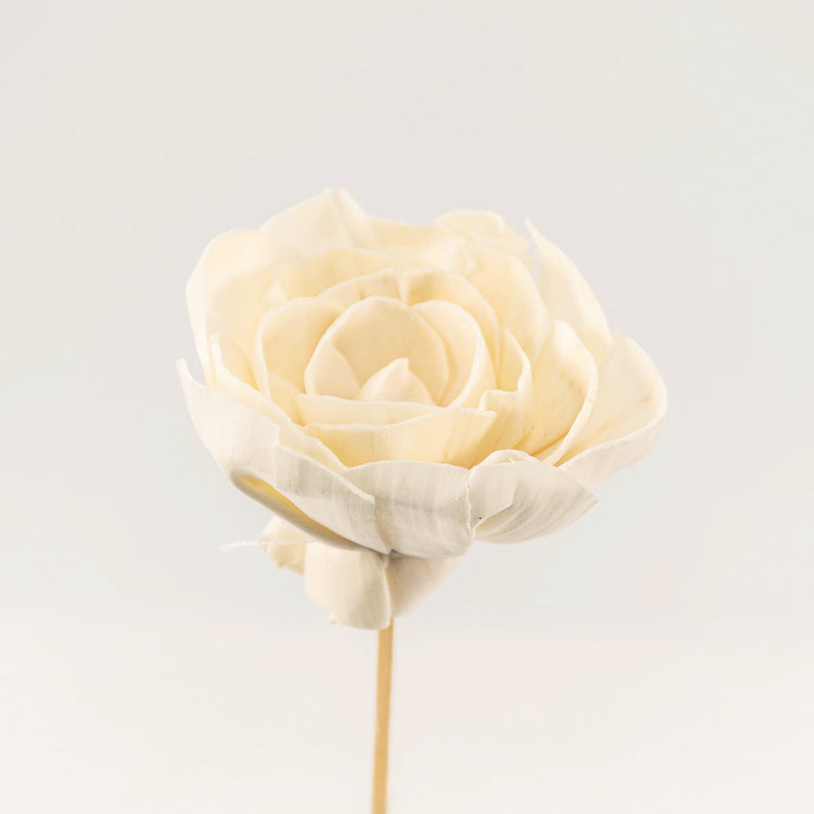 Detailed closeup of a white flower stick showing intricate petal layers and natural finish.
