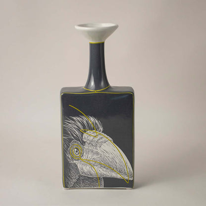 Black and white ceramic vase with artistic bird illustration placed on white background for modern home decor.