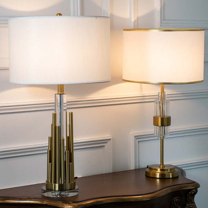 Gold metal table lamps with illuminated white drum shades displayed together highlighting stylish lighting choices for luxury home decor.