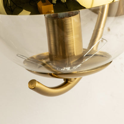 Closeup of gold metal wall light base with crystal detailing for elegant modern home interior decor styling.